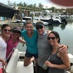 Group of guests smiling aboard the Make It So private charter boat in Key West