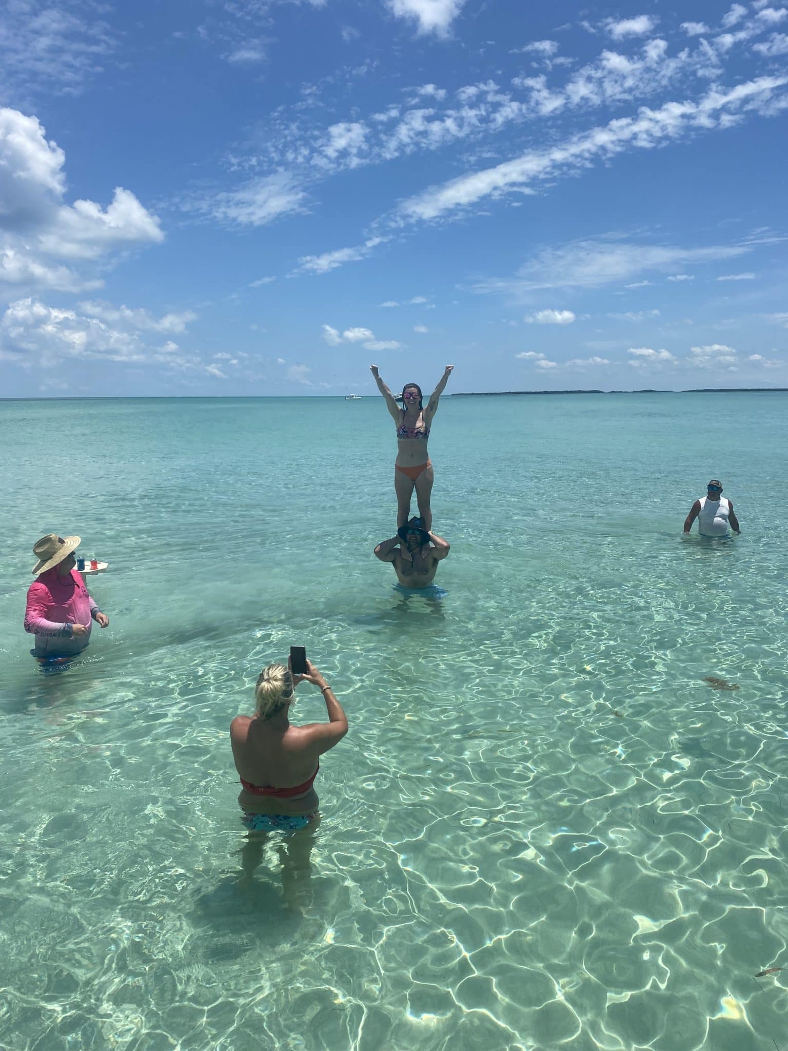 Group enjoying crystal-clear waters during a private sandbar charter in Key West, Florida Keys